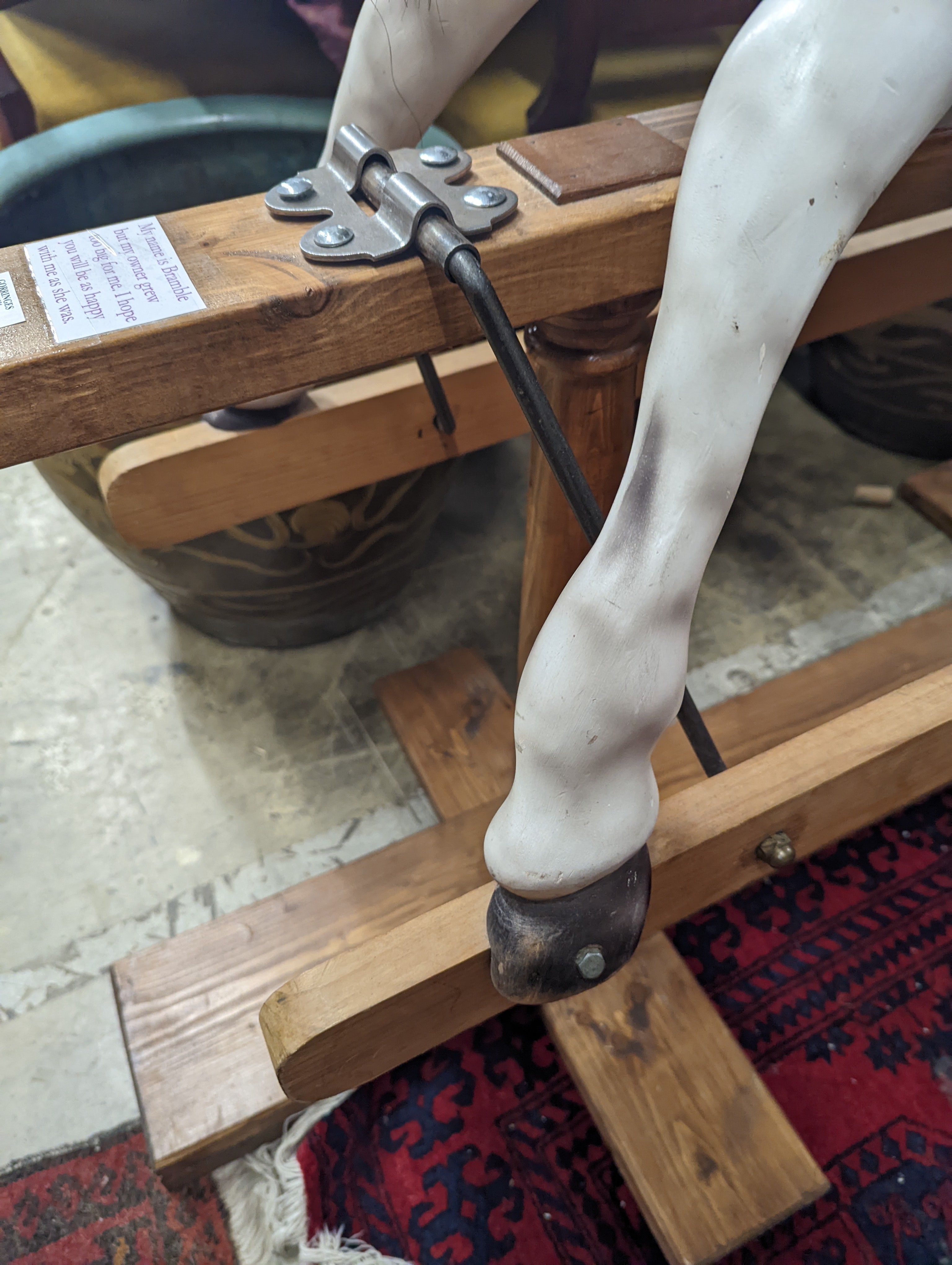 A Victorian style dapple grey rocking horse on pine stand, length 152cm, height 126cm